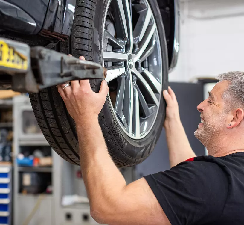 Mekaniker som skifter dekk på en bil